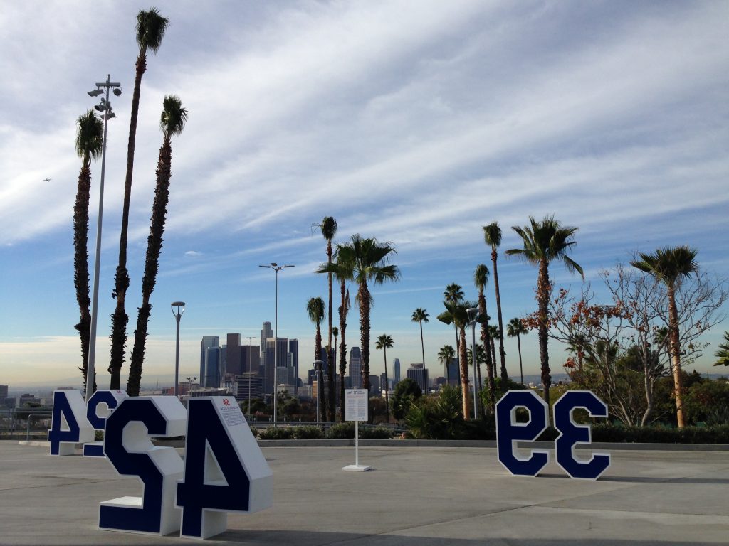 A view of the downtown skyline from Dodger Stadium's Top Deck, with relocated palm trees in the foreground. 
