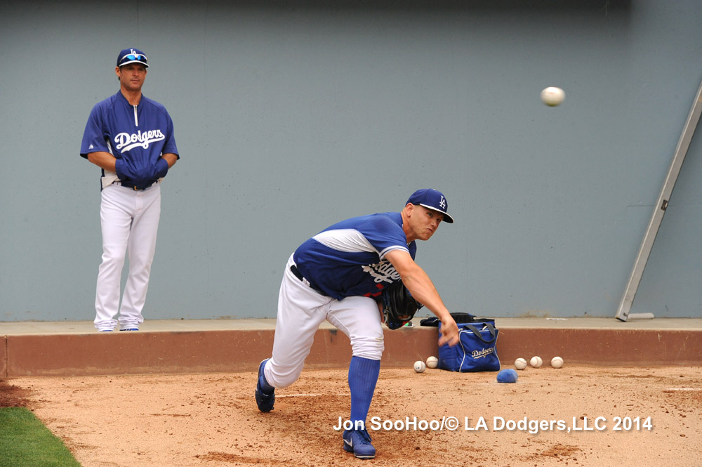 Bullpen coach Chuck Crim watches Seth Rosin on Tuesday. 