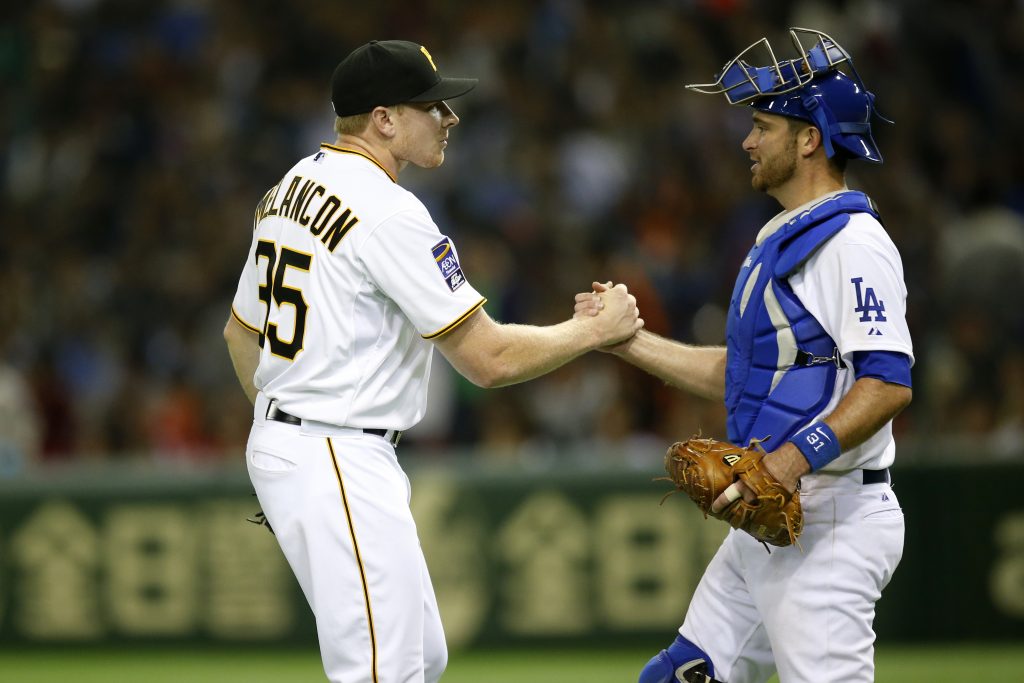 Mark Melancon and Drew Butera celebrate closing out the game. (Yuki Taguchi/MLB Photos) 