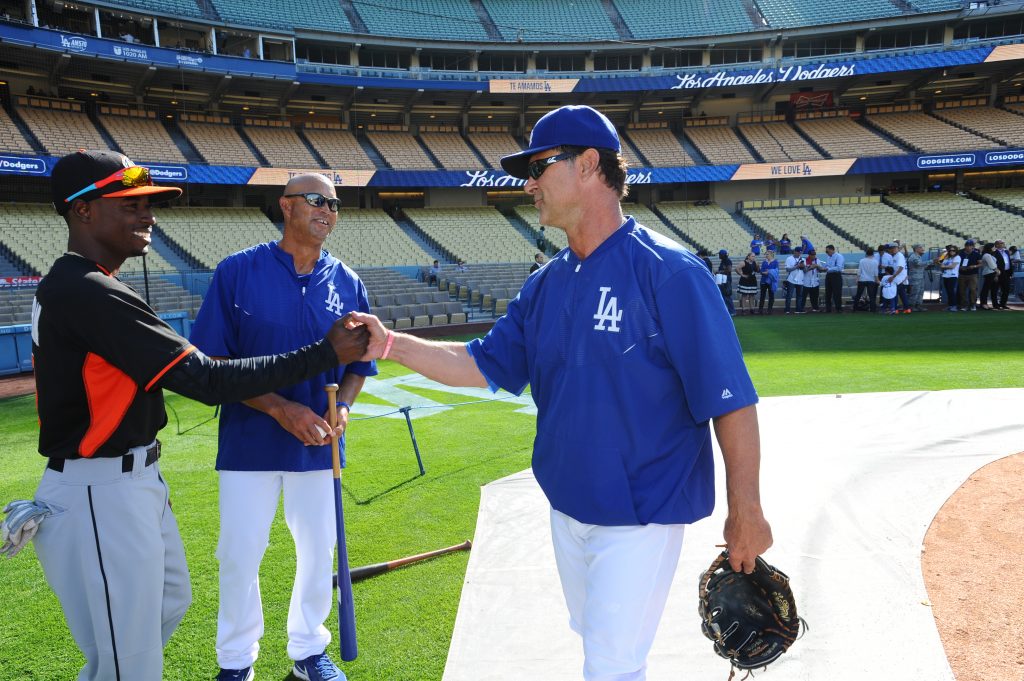 Dee Gordon says hello to Don Mattingly in his first game at Dodger Stadium as a Miami Marlin on May 11, as Lorenzo Bundy observes. (Juan Ocampo/Los Angeles Dodgers)
