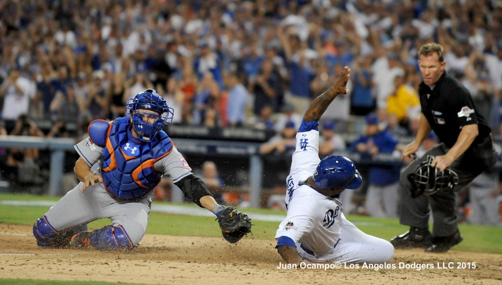 Howie Kendrick slides safely into home ahead of the tag by the Mets' Travis d'Arnaud.