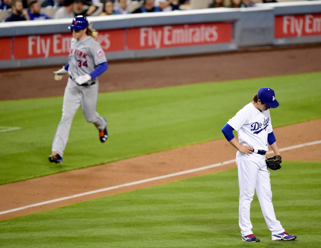 Kenta Maeda looks away from the second time around the bases by Noah Syndergaard. (Harry How/Getty Images)
